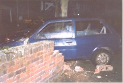 Car crashes through wall....