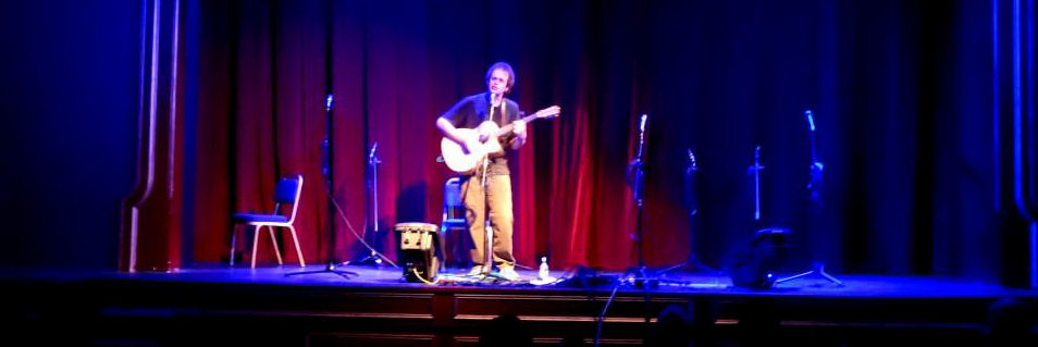 Julian Mount sings on stage.